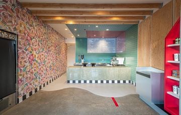 Venice apartment for rent - A kitchen with a counter and a wall with a floral pattern.