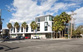 Venice apartment for rent - a building with palm trees on the corner of a street