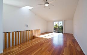 Venice apartment for rent - an empty living room with a wood floor and a ceiling fan