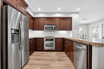 Laguna Woods apartment for rent - A modern kitchen with wooden cabinets and stainless steel appliances.