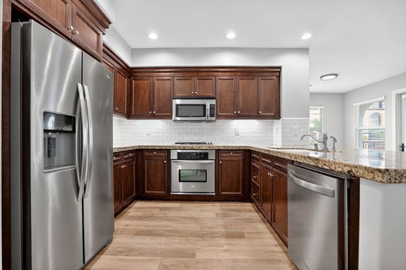 Laguna Woods apartment for rent - A modern kitchen with wooden cabinets and stainless steel appliances.