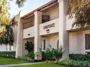 Huntington Beach apartment for rent - a large white building with a sign that says samoprono on it
