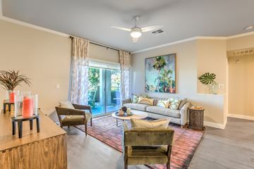 Rancho Cucamonga apartment for rent - A living room with a couch, chairs, and a table with candles on it.