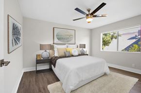 Burbank apartment for rent - a bedroom with a large bed and a ceiling fan at Palm Capri Apartments, Burbank, CA