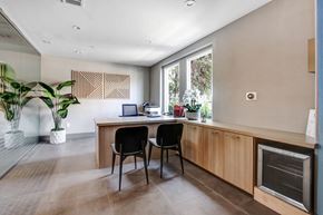 Toluca Lake apartment for rent - a home office with a wooden desk and two black chairs in front of a large window at Toluca Court, Toluca Lake, California