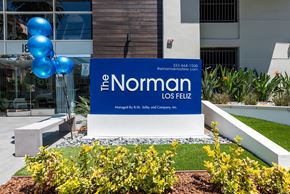 Los Feliz apartment for rent - A sign for The Norman Los Fielz is displayed in front of a building.