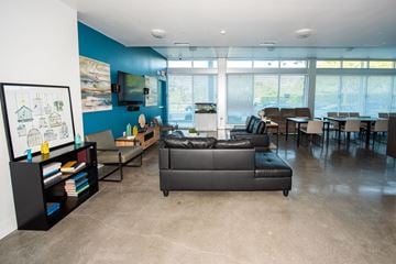 Santa Monica apartment for rent - A living room with a grey couch and a bookshelf.