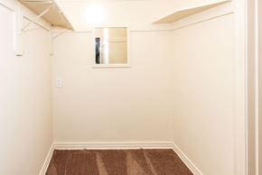 Santa Monica apartment for rent - A small room with a brown carpet and a mirror on the wall.