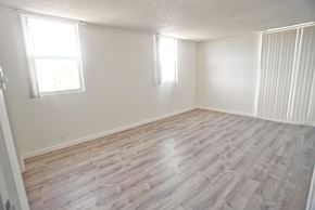 Santa Monica apartment for rent - A room with light vinyl flooring and two windows.
