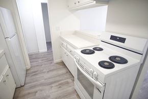 Santa Monica apartment for rent - A white stove top oven with four burners and a stainless steel oven door.