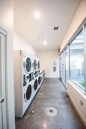 Santa Monica apartment for rent - A row of washing machines and dryers in a laundry room.