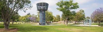 Santa Monica apartment for rent - A large water tower in a park with trees and a playground.