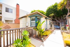 Santa Monica apartment for rent - A small house with a green door and a brown fence.