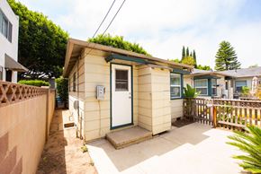 Santa Monica apartment for rent - A small house with a green plant on the roof.