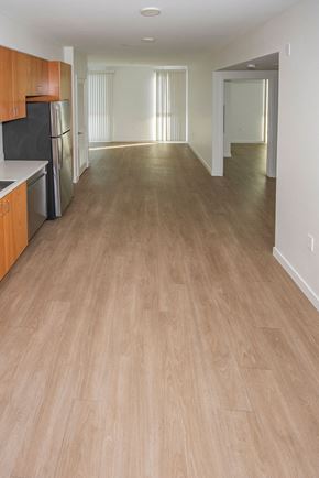 Santa Monica apartment for rent - Sample 2 Bedroom Unit: A kitchen with vinyl floors and a black fridge.