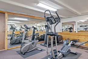 St Cloud apartment for rent - a gym with various exercise bikes and weights in it