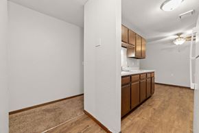 Braham apartment for rent - A kitchen area with wooden floors and white walls.