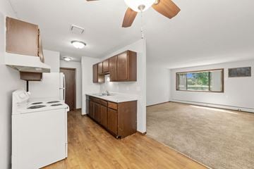 Braham apartment for rent - A kitchen with a white stove and wooden cabinets.