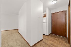 Braham apartment for rent - A room with a brown door and a white wall.