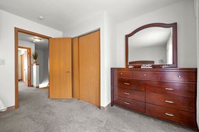 Burnsville townhouse for rent - A bedroom with a dresser and mirror.