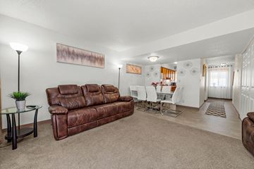 Burnsville townhouse for rent - A living room with a brown leather couch and a glass coffee table.