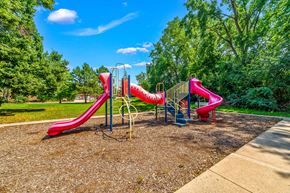 Burnsville townhouse for rent - A playground with a red slide and a blue sky.