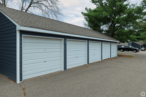 Stillwater apartment for rent - A row of three garage doors in a blue building.