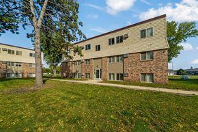 Redwood Falls apartment for rent - A building with a tree in front of it.