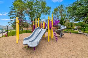 Coon Rapids apartment for rent - A playground with a purple slide and yellow poles.