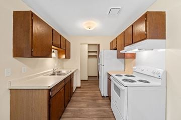 Oakdale apartment for rent - A kitchen with white appliances and wooden cabinets.