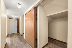 Oakdale townhouse for rent - A hallway with a white door and a brown door.