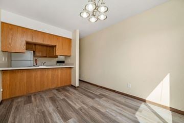 Oakdale townhouse for rent - A kitchen with wooden cabinets and a refrigerator.