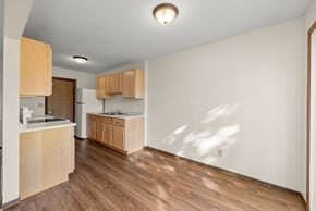 Faribault townhouse for rent - A kitchen with wooden floors and cabinets.