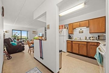 Granite Falls apartment for rent - A kitchen with wooden cabinets and a refrigerator in the middle.