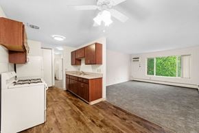 Maplewood apartment for rent - A kitchen with wooden cabinets and a white stove.