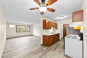 Sandstone apartment for rent - A kitchen with a white dishwasher and wooden cabinets.