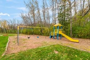 Sandstone apartment for rent - A playground with a yellow slide and a blue and yellow tower.