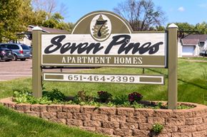 Forest Lake apartment for rent - A sign for Seven Pines Apartment Homes with a phone number on it.