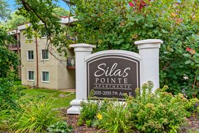 North St Paul apartment for rent - A sign for Dilla's Pointe Apartments stands in front of a building.