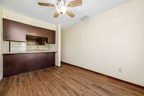 Forest Lake townhouse for rent - A room with a ceiling fan and wooden floors.
