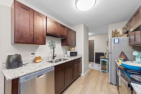 Forest Lake apartment for rent - A kitchen with brown cabinets and a white counter top.