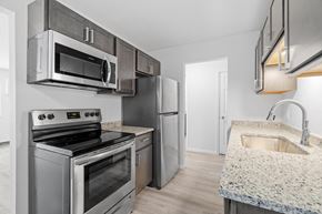 St Cloud apartment for rent - a kitchen with stainless steel appliances and granite counter tops and