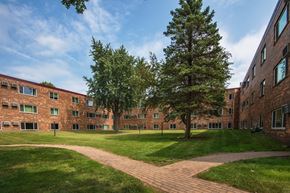 Marshall apartment for rent - the exterior of a brick building with grass and trees