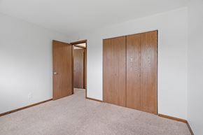St Cloud apartment for rent - a bedroom with two closet doors and a carpeted floor