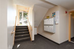 Owatonna apartment for rent - a staircase leading up to a room with a window and a door