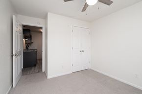 Owatonna apartment for rent - an empty bedroom with white walls and a ceiling fan