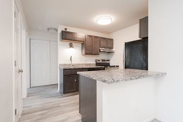 Owatonna apartment for rent - a kitchen with a counter top and a refrigerator