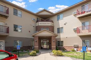 Saint Cloud apartment for rent - the exterior of a building with a red car parked in front