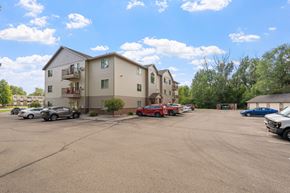 Saint Cloud apartment for rent - an empty parking lot with cars in front of apartment buildings