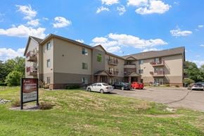 Saint Cloud apartment for rent - an apartment building with a sign in front of a parking lot